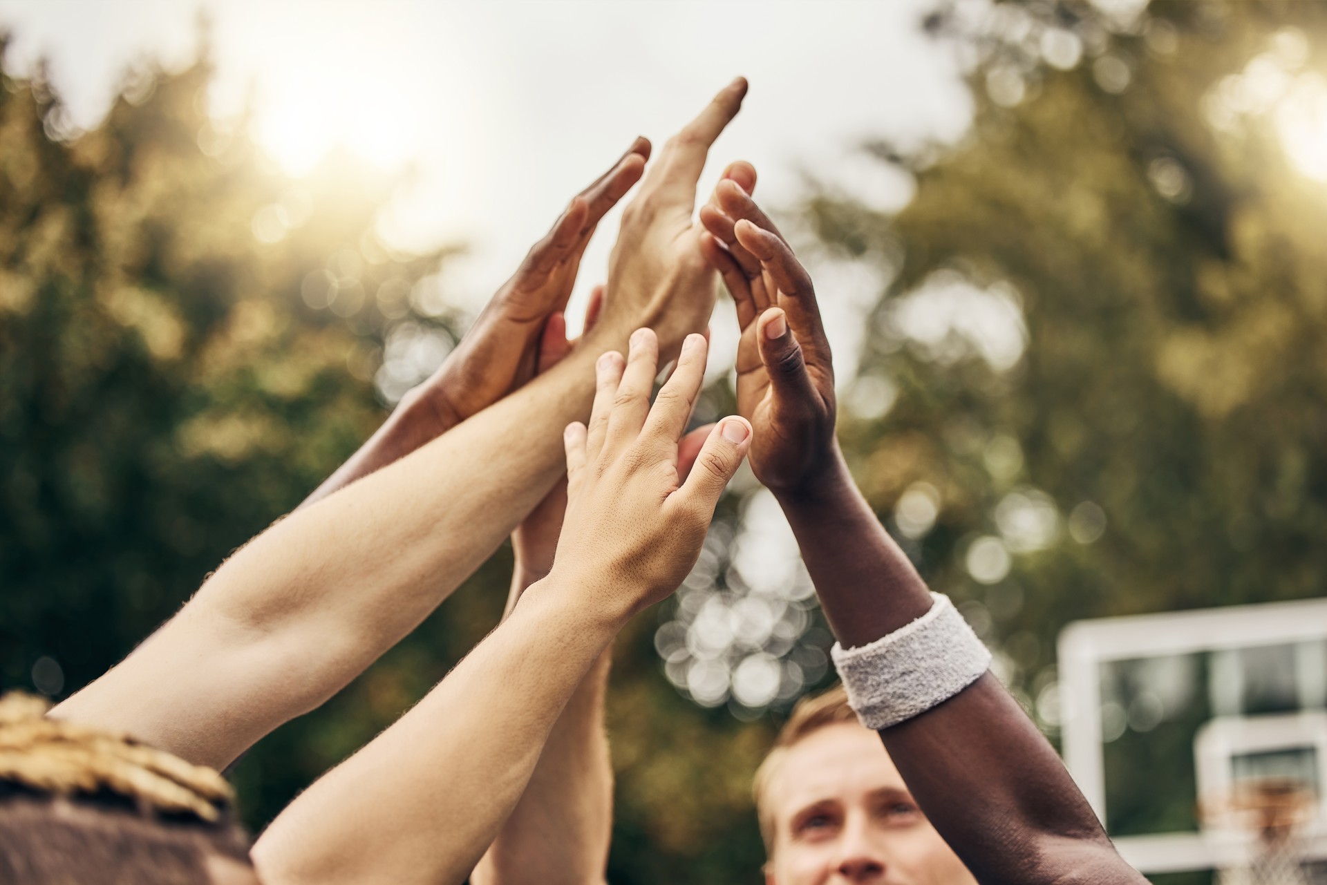 Basketball, winner and hands, team high five for outdoor game. Success, diversity and victory goal for sports for men. Teamwork, diversity and support, friends on basketball court together with coach